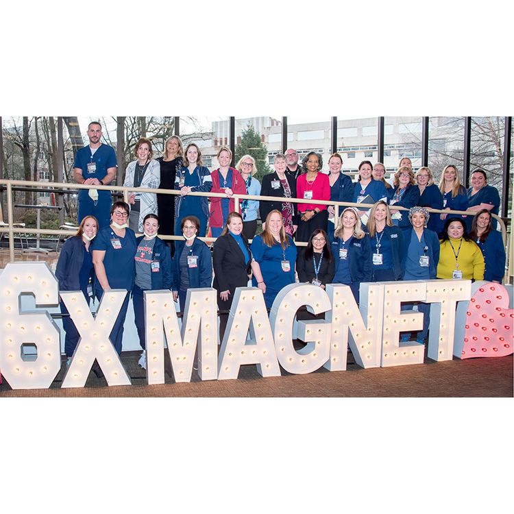 Group of nurses stand for a photo for the American Nurses Association Magnet Award for Nursing Excellence.