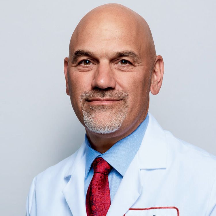 Professional headshot of Dr. Uzzo